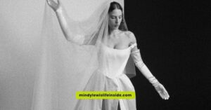 A woman in a stunning Vivienne Westwood wedding dress poses elegantly for the camera, showcasing intricate design details.