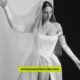 A woman in a stunning Vivienne Westwood wedding dress poses elegantly for the camera, showcasing intricate design details.