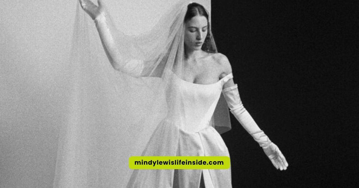A woman in a stunning Vivienne Westwood wedding dress poses elegantly for the camera, showcasing intricate design details.