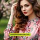 Elegant woman wearing a pink floral dress, adorned with flowers, highlighting a chic and fashionable look.