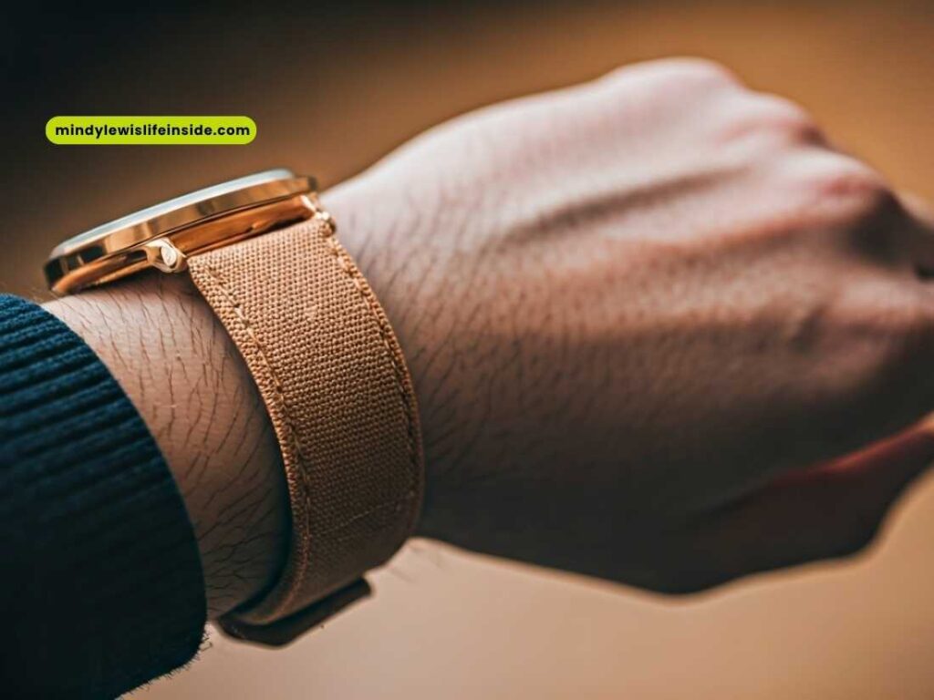 A close-up of a person's wrist featuring a tan watch, illustrating the choice of wearing a watch on either wrist.