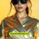 A woman in a chic gold dress and sunglasses, embodying the essence of trendy Y3K outfits.