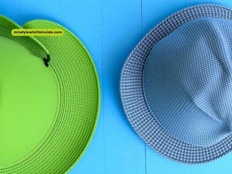 Two hats displayed on a blue surface, illustrating options for headwear after Botox treatment.