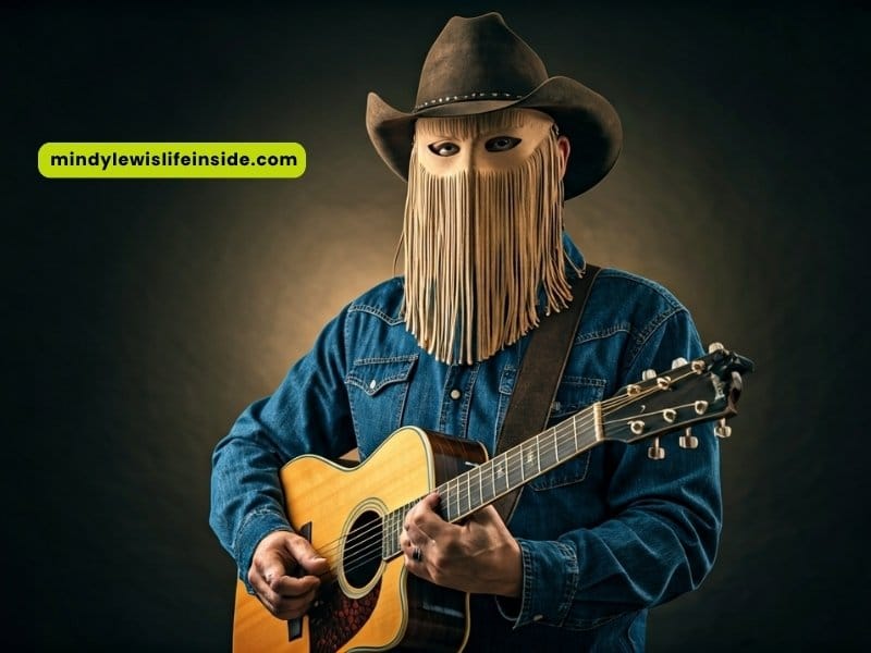 A man in a cowboy hat holds an acoustic guitar, ready to play music in a lively outdoor setting.
