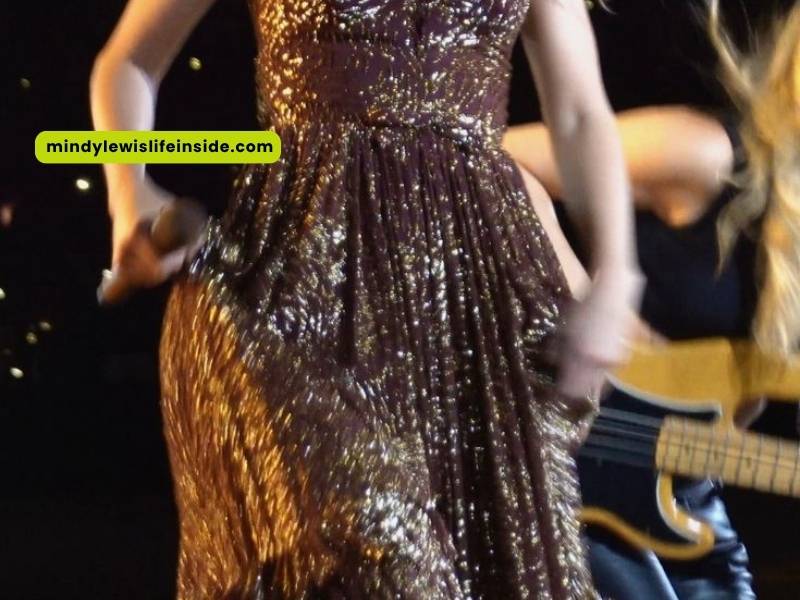 Taylor Swift dazzles in a gold dress during her concert, symbolizing the artistry of the Evermore era.