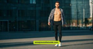 A shirtless man stands in front of a building, embodying a casual attitude towards fashion and self-expression.