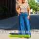 Older women confidently wearing wide-leg jeans, showcasing style and comfort in a casual setting.