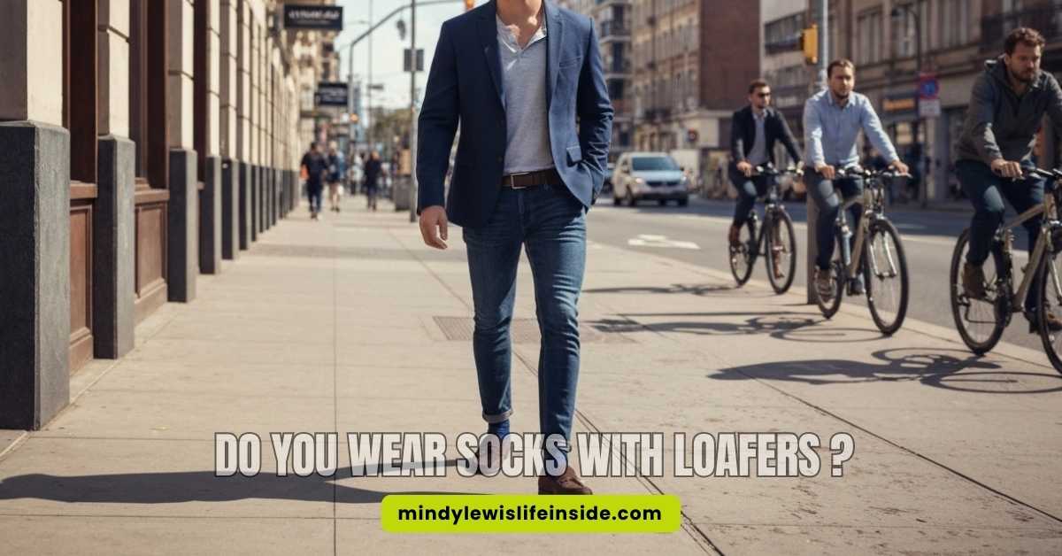 A stylish man in a suit and loafers, pondering whether to wear socks with his loafers.