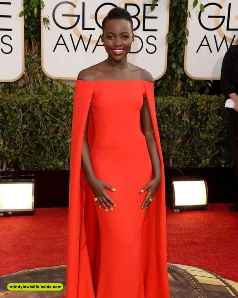 Lupita Nyong'o elegantly dressed at the Golden Globe Awards, showcasing a stunning outfit at this prestigious celebrity event.