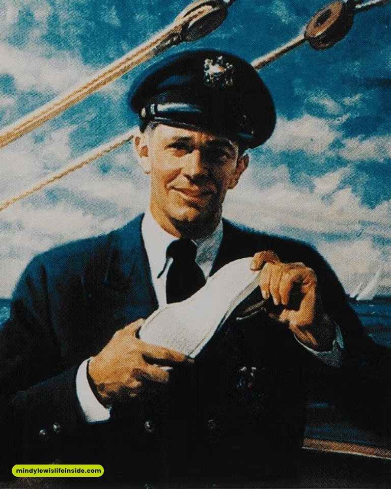 A man in a naval uniform and cap smiles while polishing a shoe on a ship's deck. The sky is bright blue, and rigging ropes are visible. The mood is cheerful and professional.